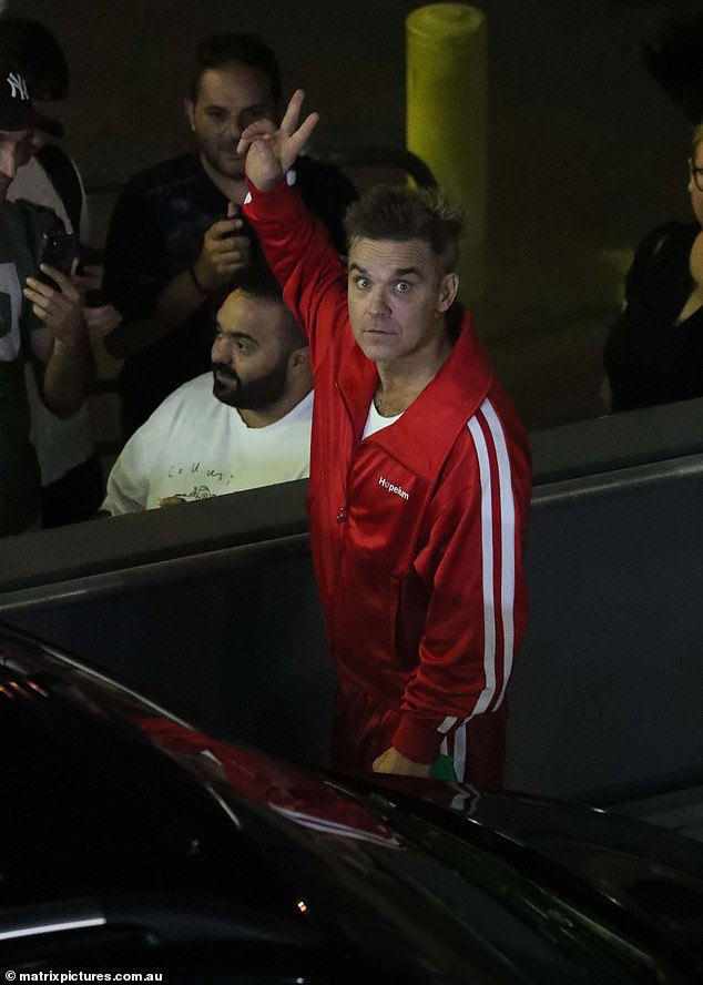 The Better Man star is comfortably dressed in a red tracksuit paired with a white singlet