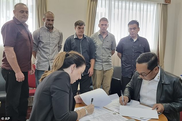 Two weeks after returning home to Australia, after twenty years in an Indonesian prison, drug smuggler Scott Rush (middle of the photo, briefly in green) appeared in court in Brisbane on Monday.