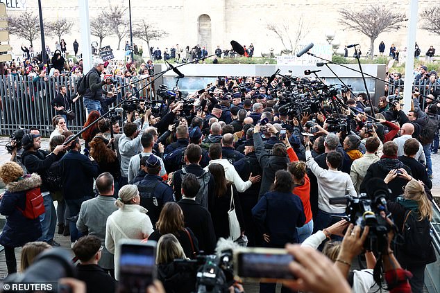 Gisele Pelicot leaves the courthouse surrounded by French police and journalists after the trial verdict on December 19