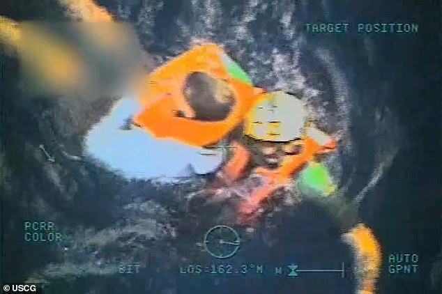 Dramatic footage shows a coastguard member jumping into choppy waters to rescue the men, grabbing their stomachs