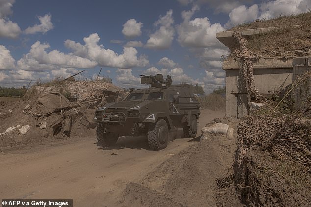 A Ukrainian military vehicle drives past a destroyed border crossing with Russia in the Kursk region. Russia has retaken at least half of the territory and is sending thousands of additional troops to the region