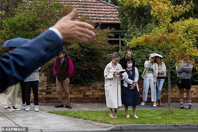 Melbourne was the worst performing property market in Australia's capital in 2024, despite a large influx of foreign migrants (photo, an auction in Melbourne)