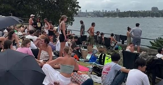 14238041 Chaotic moment, huge crowds ignore New Year's Eve rules and race to the best viewing spots in Sydney, before the fireworks