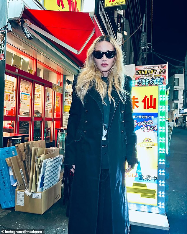 Sticking to her gothic color palette, she also shared a photo of herself posing in front of bright LED lights outside a store. Even though it appeared to be dark outside, she wore oversized wraparound sunglasses