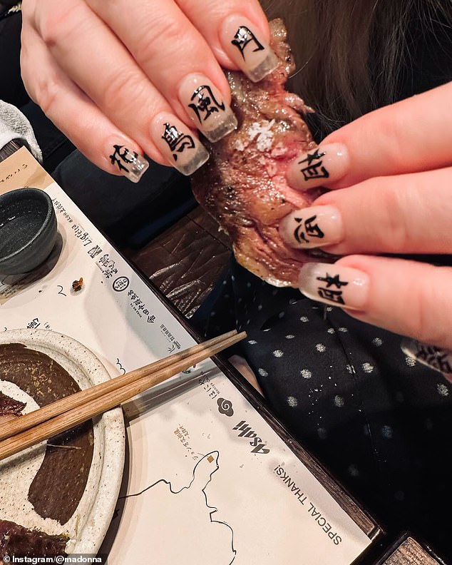 She also posted a photo of her kanji manicure as she picked up some of her food with her bare hands