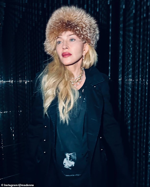 She also shared a photo of her outfit, which featured lots of gold chains around her neck and a fluffy hat on her head