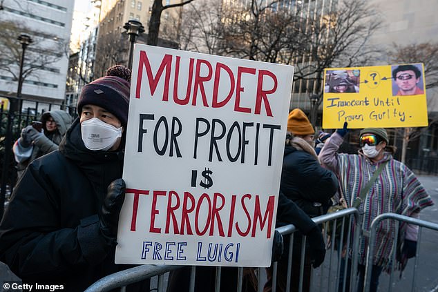 Protesters carried signs outside the Manhattan Criminal Court urging Mangione's freedom