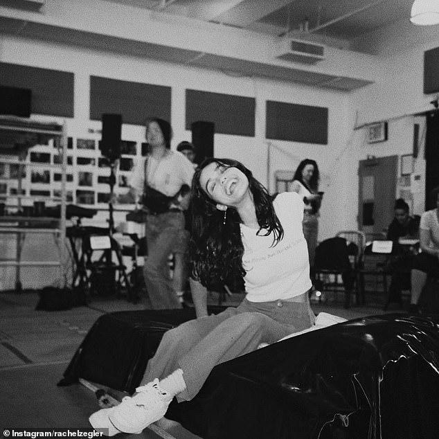 Then, in what appeared to be a rehearsal room, she was snapped smiling brightly in a candid, black-and-white snap.