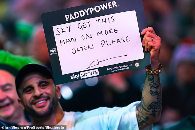 Walker was seen holding a sign in the crowd as he observed the action at Alexandra Palace