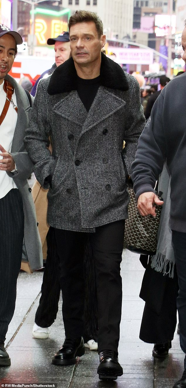 Seacrest was fashionable in a black and white double-breasted peacoat with a stylish fur collar