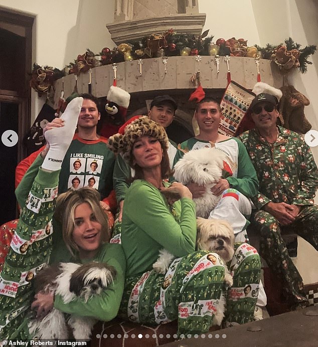 Ashley then shared a heartwarming festive photo of herself and her family, all dressed in matching green Elf pajamas as they gathered by the fireplace.