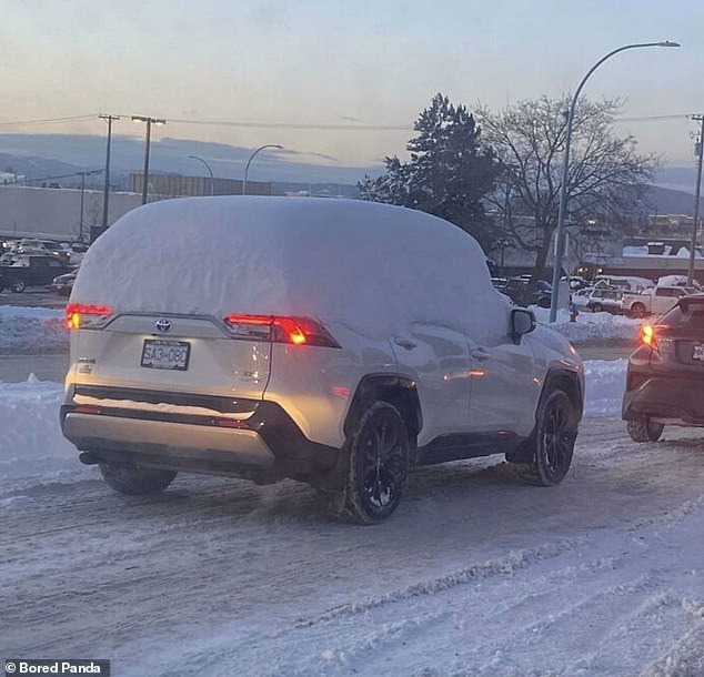 Snow joke! This motorist decided to go out for a day with his car - and windows - still completely covered in snow