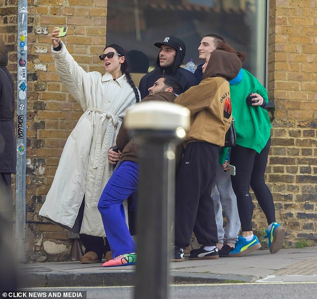 The singer was joined by a group of friends for the outing which saw the hitmaker take a photo of the gang outside the studio