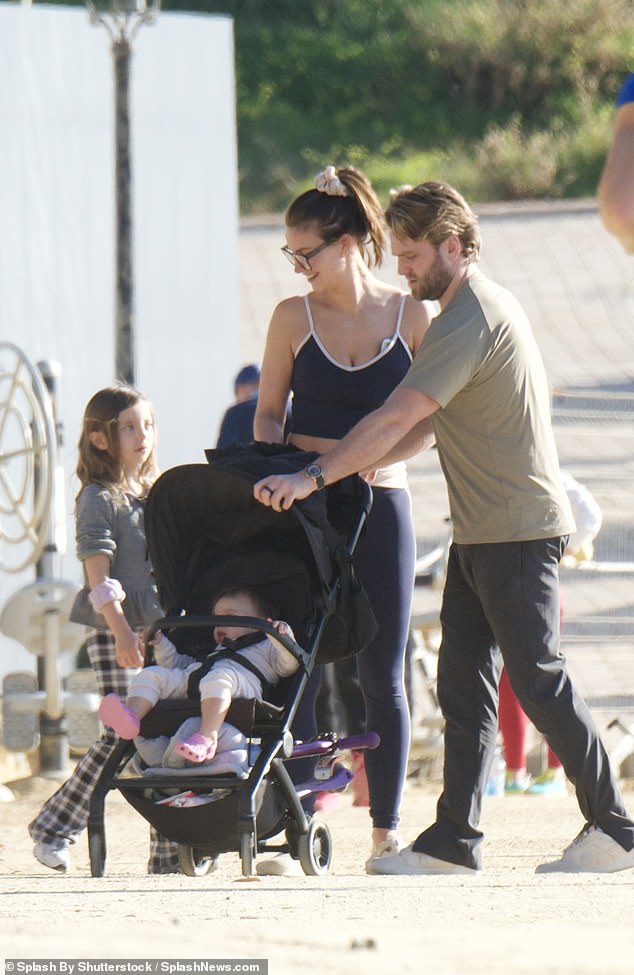 Ferne looked sporty and stylish in a navy blue crop top with matching leggings with white stripes on the side