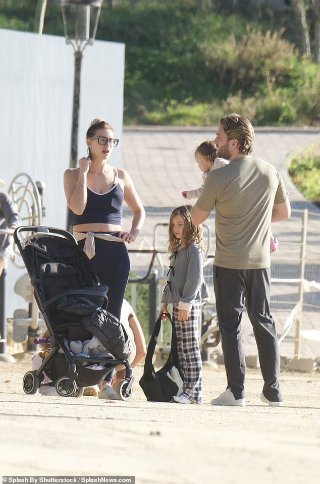 She went makeup-free and wore her hair up on her head as she held hands with daughter Sunday, six, from a previous relationship