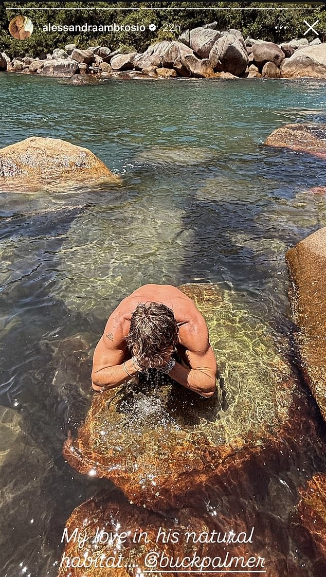 The stunner also snapped a photo of Buck washing his face in the ocean, captioning it: 