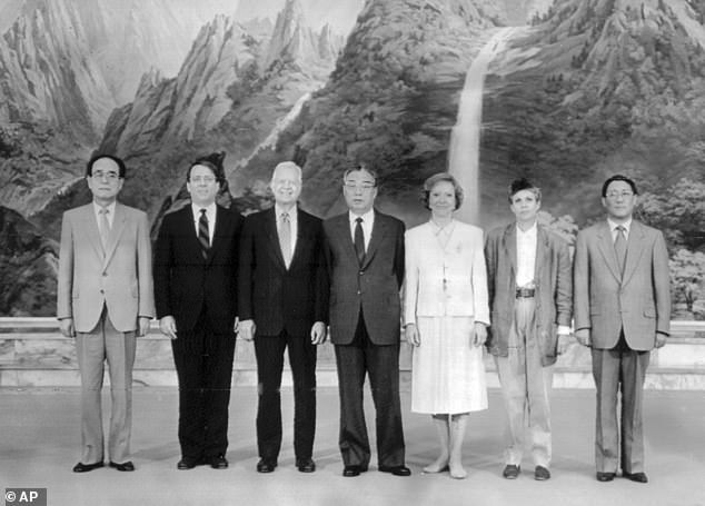 In this June 16, 1994 file photo provided by the North Korean government, then-North Korean leader Kim Il Sung, center, poses with former U.S. President Jimmy Carter, third from left