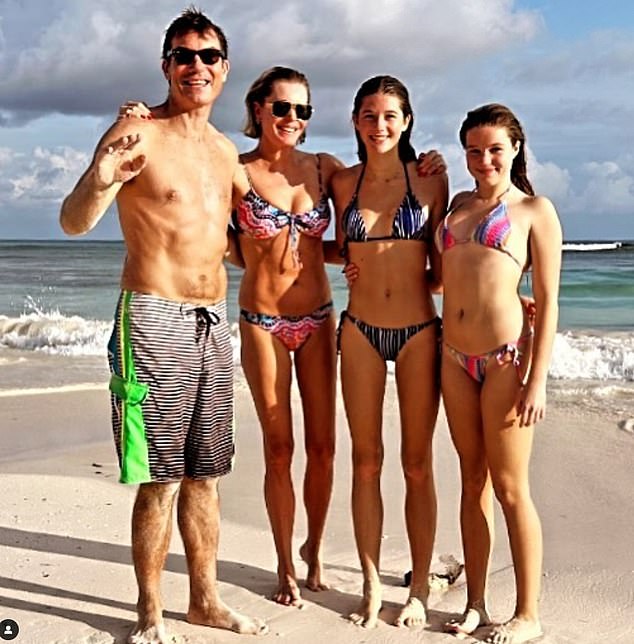 And this image shows the girls at the age of 15 with their parents on the beach