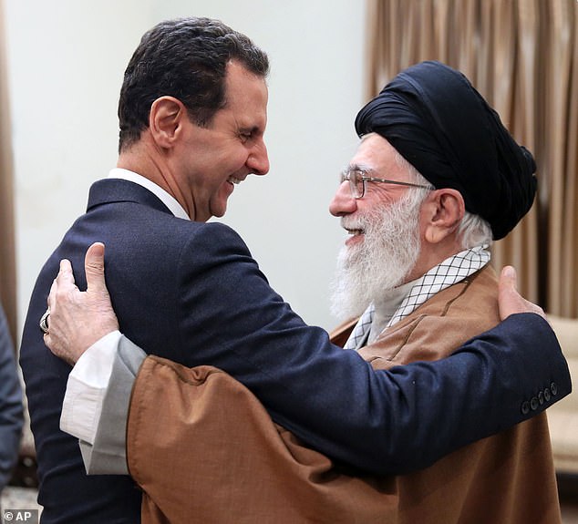 Former Syrian President Bashar Assad greets Iran's Supreme Leader Ayatollah Ali Khamenei