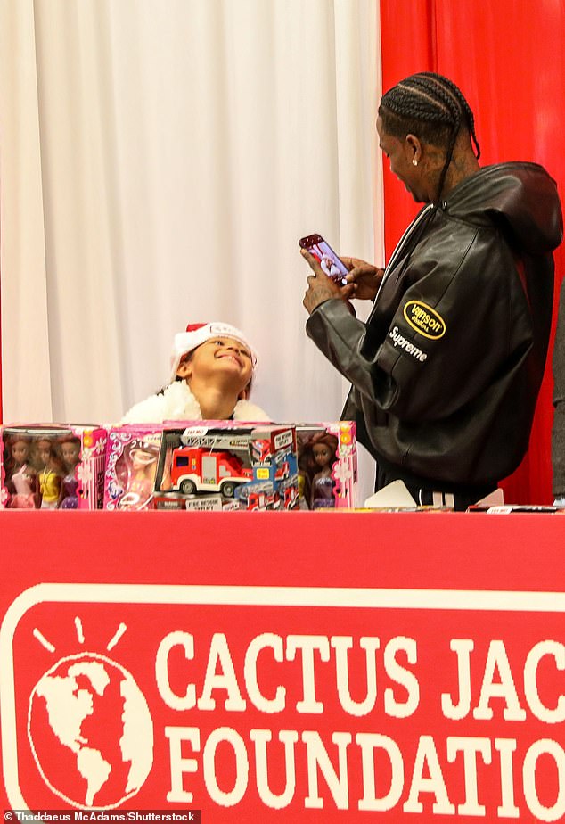 The proud dad, 33, snapped a photo of his little girl as she manned the toy stall