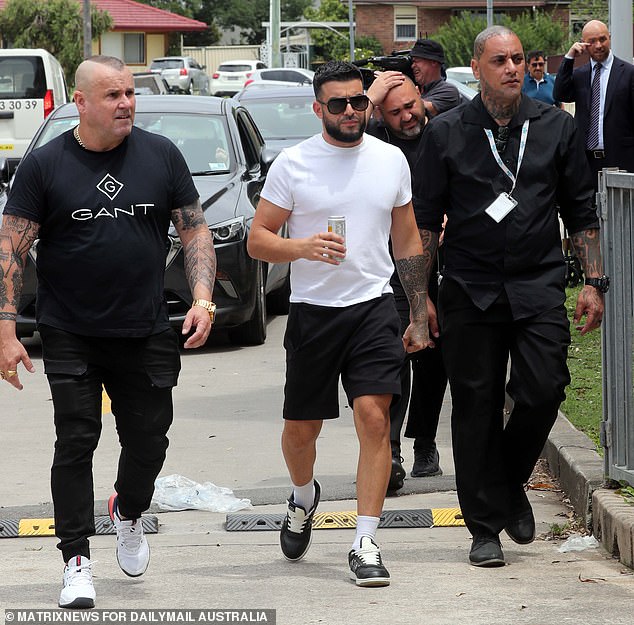 Hundreds of people turned out in Penrith and West Fairfield as billionaire Adrian Portelli (centre) handed out $150,000 Coles vouchers to 1,000 families