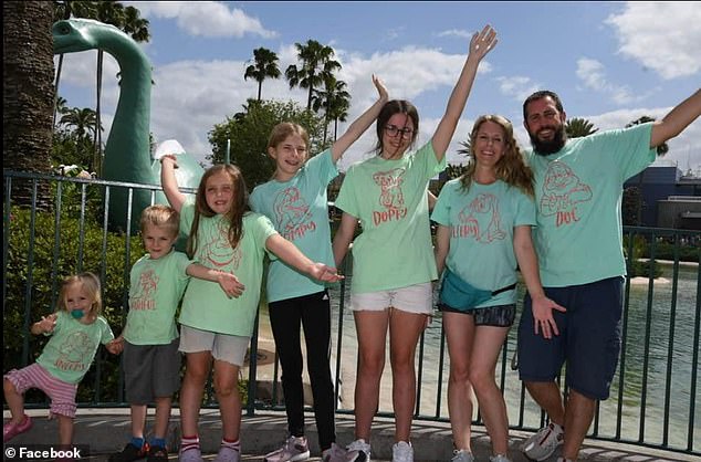 Michael is pictured with his wife, four daughters and son Hunter