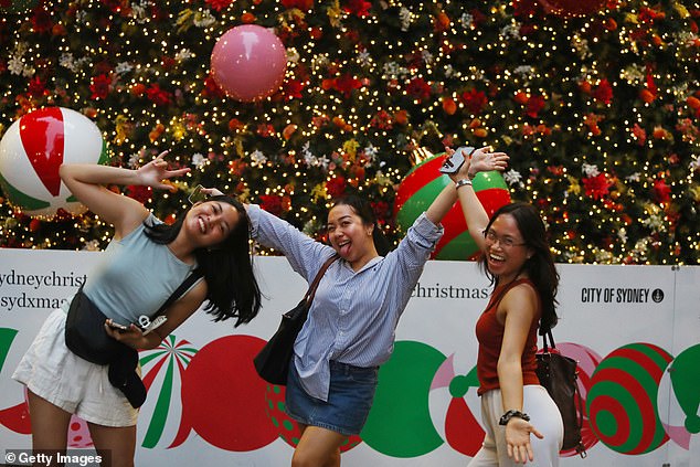 Many Aussies are unhappy about being forced to take annual leave over the Christmas period. Pictured: Sydneysiders celebrating the holidays at Martin Place