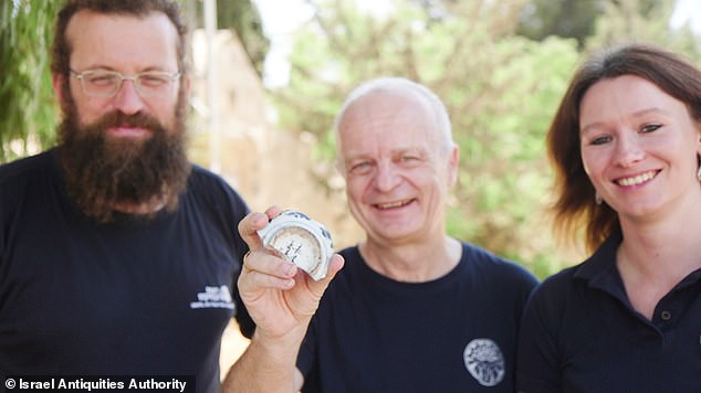 Above, Director General of the German Protestant Institute of Archaeology, Dr. Dieter Vieweger, holding the new fragment next to IAA archaeologist Michael Chernin (left) and his colleague from the Protestant Institute, postdoctoral researcher Dr. Jennifer Zimmi (right)