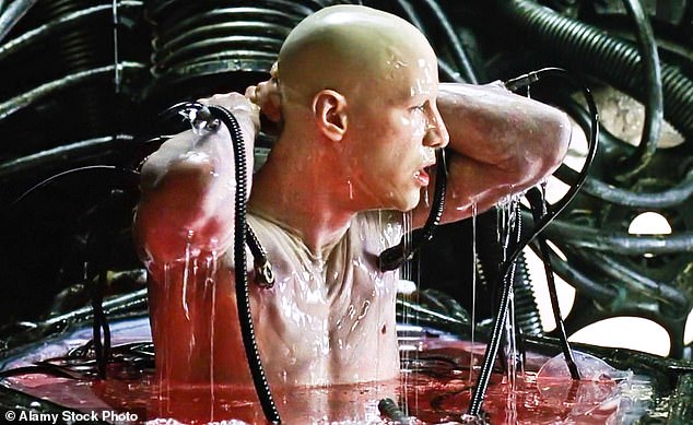 In the classic blockbuster film The Matrix, humans are enslaved by AI because they want our body heat to power their computers. Pictured is Keanu Reeves as Neo who wakes up in the real world