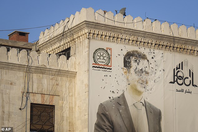 An image of Syrian President Bashar Assad riddled with bullets is seen on the facade of the provincial government office in the aftermath of the opposition's takeover of Hama, Syria, Friday, December 6, 2024