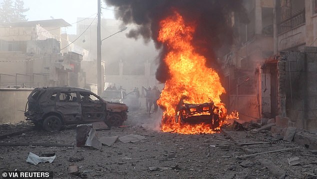 A view of a vehicle on fire in the aftermath of what the White Helmets say is a strike, in Idlib, Syria, released December 1, 2024