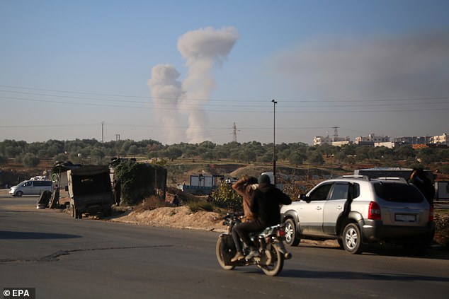 Smoke rises after airstrikes in Idlib, northern Syria, December 1, 2024