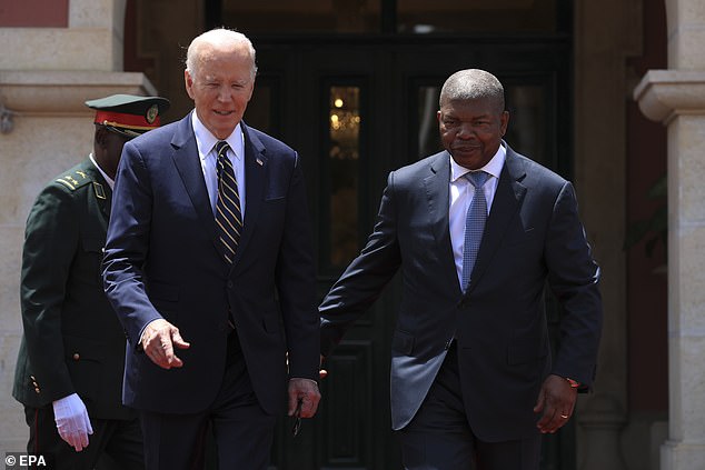 President Joe Biden (left) is led to a podium by Angolan President João Lourenço (during) during an arrival ceremony Tuesday at the presidential palace in Luanda