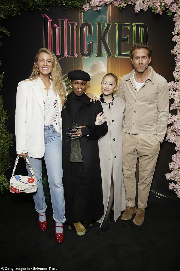 Blake Lively and her husband Ryan Reynolds towered over Wicked stars Ariana Grande and Cynthia Erivo at a special screening of the musical film on Tuesday