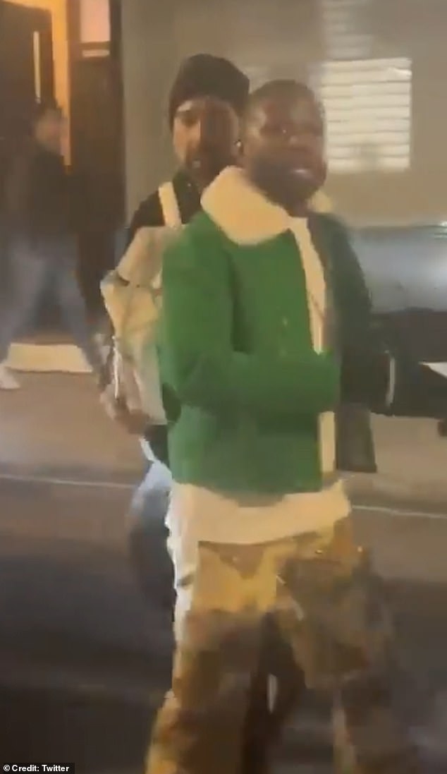 Boxing legend Floyd Mayweather, seen in a green jacket and camouflage pants, appeared visibly distressed as he was reportedly attacked by a crowd while shopping in London