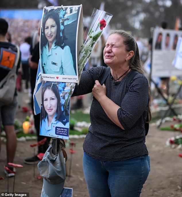 A woman collapses at the memorial to Yulia Waxer Daunov as relatives and friends of the lost and abducted gather at the site of the Nova Festival marking the one-year anniversary of the Hamas attacks