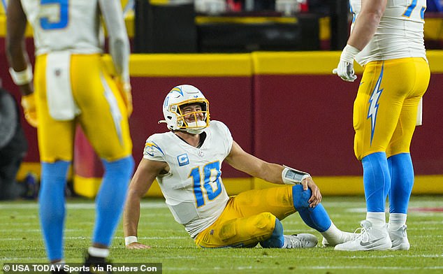 Chargers quarterback Justin Herbert (10) reacts after suffering an injury in the first half