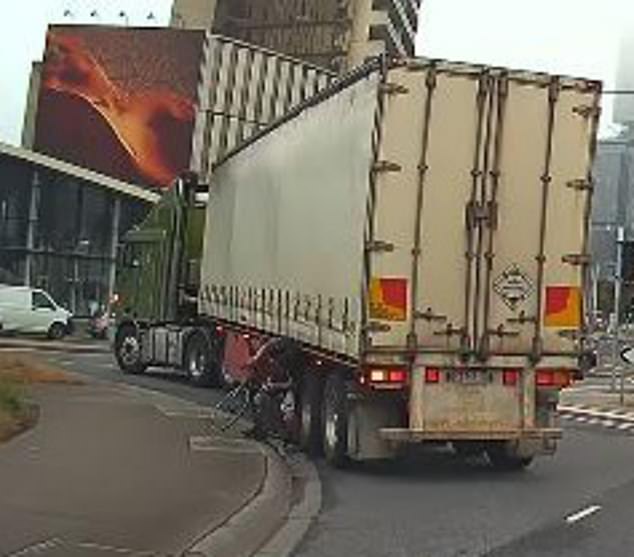 During the close call, the cyclist became trapped in the underbelly of the semi-trailer