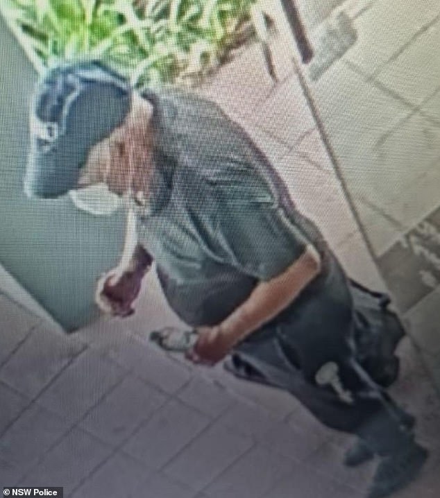 NSW Police released CCTV footage of a man wanted for questioning over suspected arson attacks on two buildings on Thursday evening (pictured)