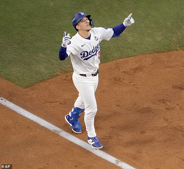 Tommy Edman celebrates as he reaches home plate after hitting his solo home run in Game 2