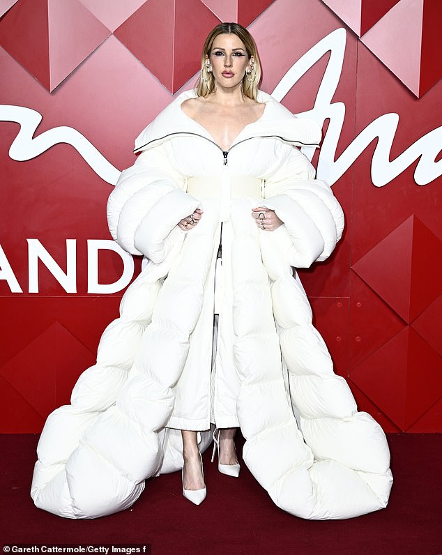 Ellie Goulding made sure all eyes were on her as she graced the red carpet in a dramatic white coat at the Fashion Awards at London's Royal Albert Hall on Monday