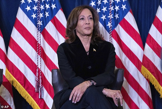 Vice President Kamala Harris listens as first lady Jill Biden speaks at the Democratic National Committee holiday reception