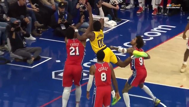 Joel Embiid takes a forearm and elbow to the face late in the first half of the 76ers game