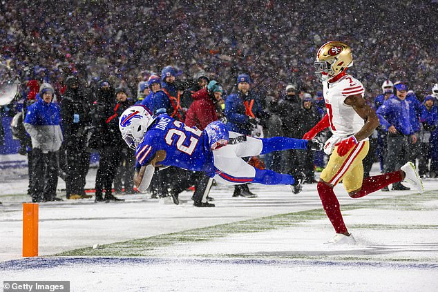 Ray Davis dives into the end zone for the first touchdown on a snowy night in Buffalo, New York