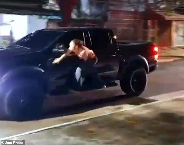 Dr. Dayana Segtowich was caught on camera hanging off the side of a pickup truck driven by her husband after she caught him cheating on her with another woman