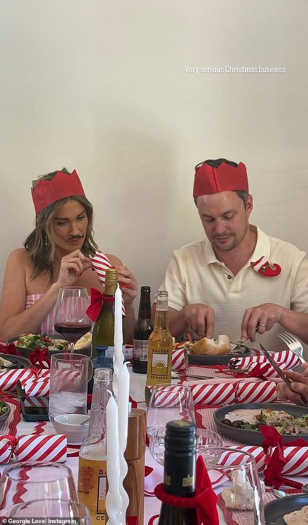 In one photo, Georgia sat next to a man wearing a ring on his finger – perhaps a married friend – while she was busy playing with a toy inside a Christmas chocolate.