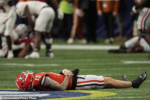 Georgia quarterback Carson Beck (15) is injured on the turf during the first half against Texas