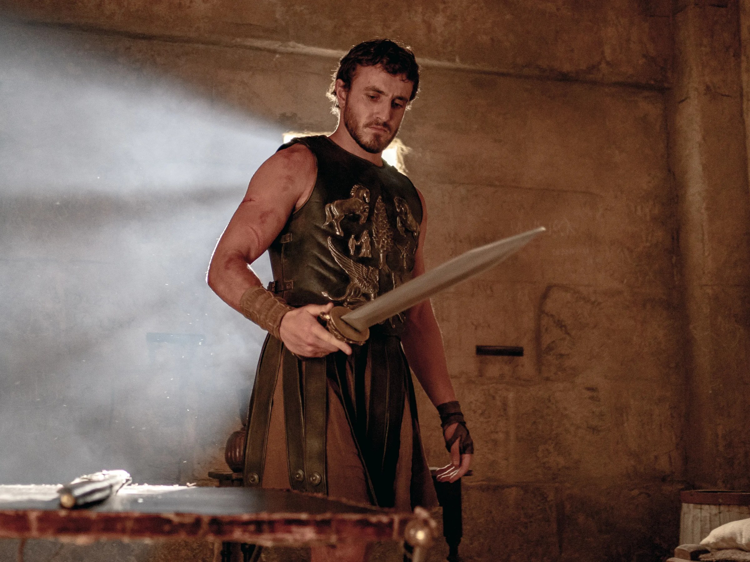 Paul Mescal in gladiator armor with a sword in Gladiator II