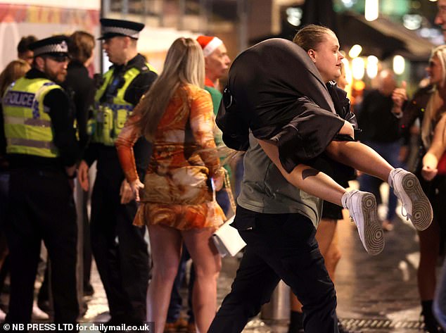 LEEDS: The man then carries his girlfriend down the street in Leeds