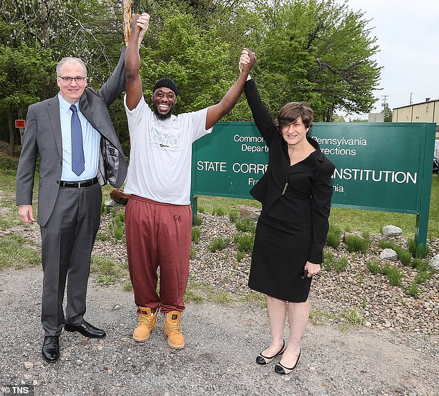 After his release, the Innocence Project celebrated the overturning of Shaurn Thomas's (center) conviction, with some lawyers meeting him outside the prison. Pictured with attorneys James Figorski and Marissa Bluestine (left and right)